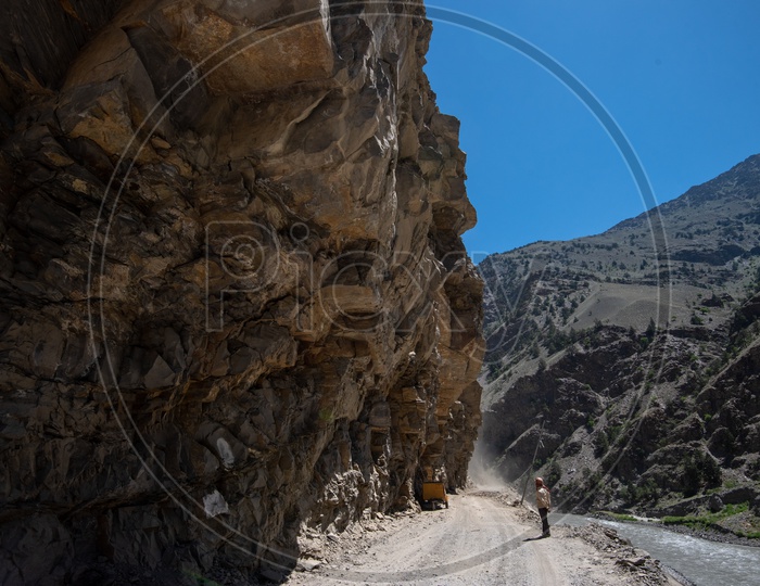 A man standing on the dusty mountain Spiti Valley road