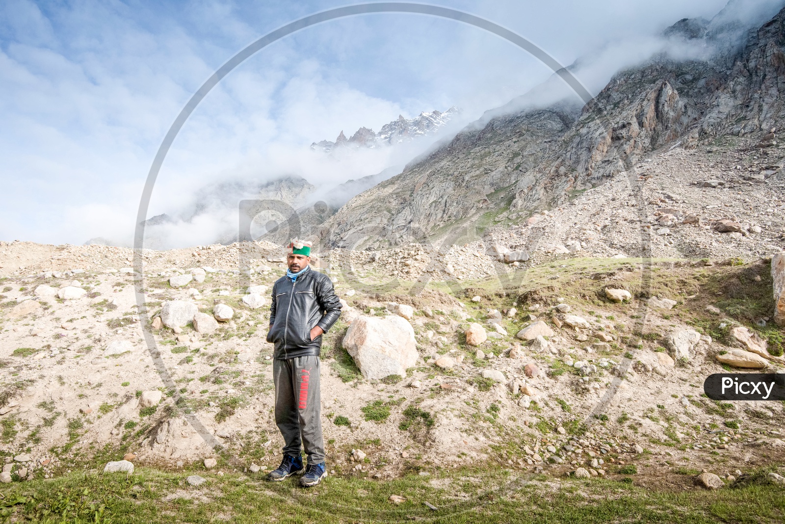 A man  standing in the barren lands of Spiti Valley