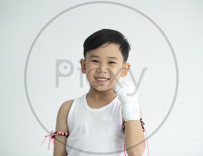 A Young Thai  Boxer Wearing Boxer Gloves and Posing