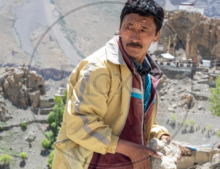 Local Man Carrying the Stones in hand in Leh