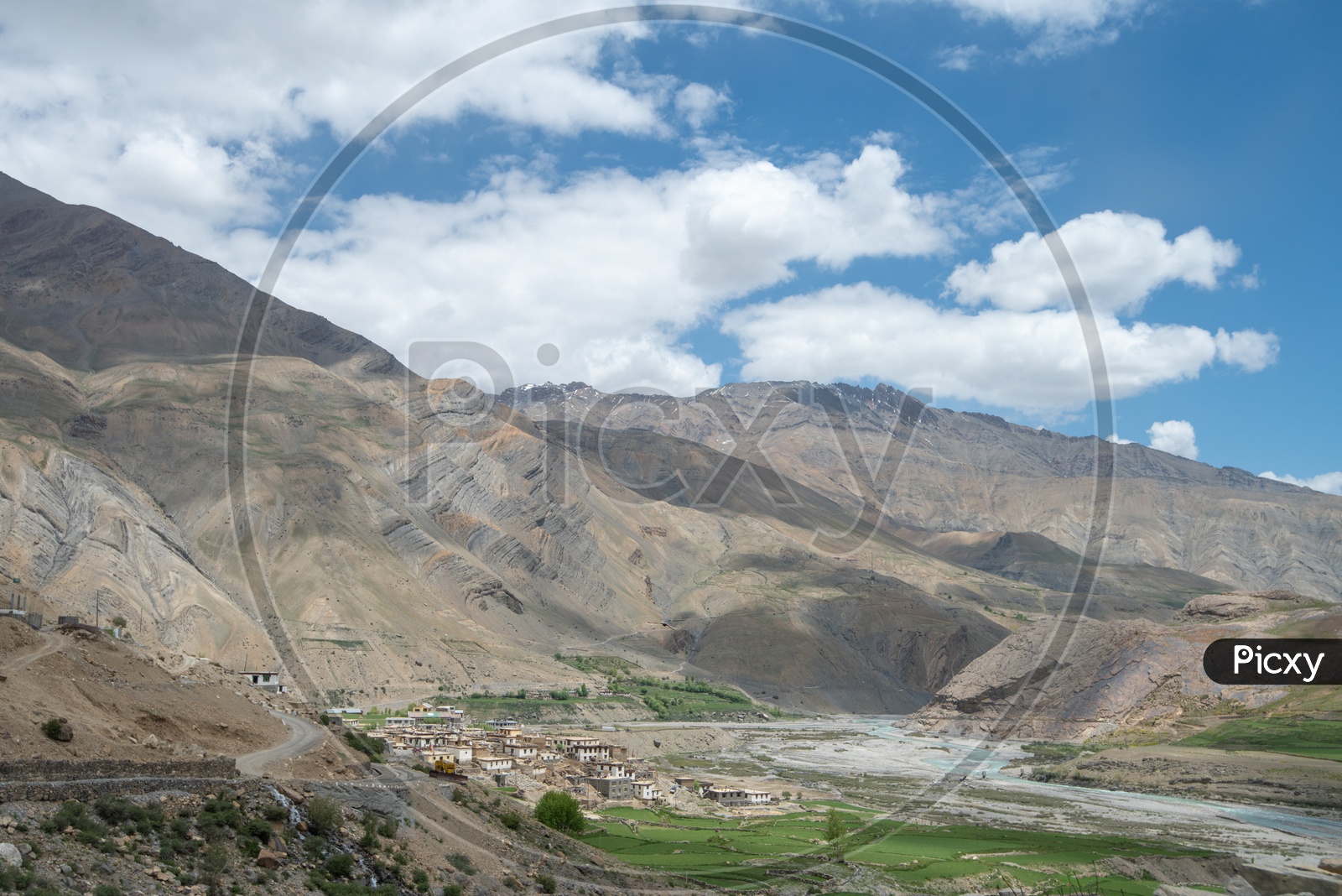 Agricultural farm lands and houses beside Spiti river with mountains in the background in Spiti Valley