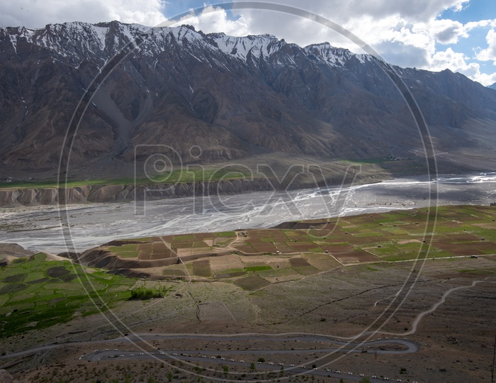 Roads and agricultural farm lands beside the river in Spiti Valley