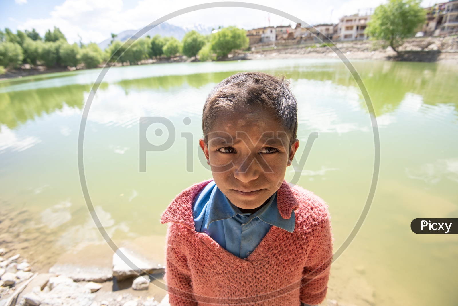 Portrait Of a Young Boy Or Child  Standing At a Lake In Leh Villages