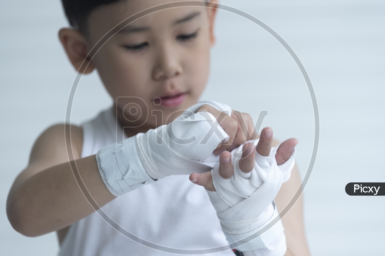A Young Thai Boy  Boxer Wrapping His Hand For Boxing