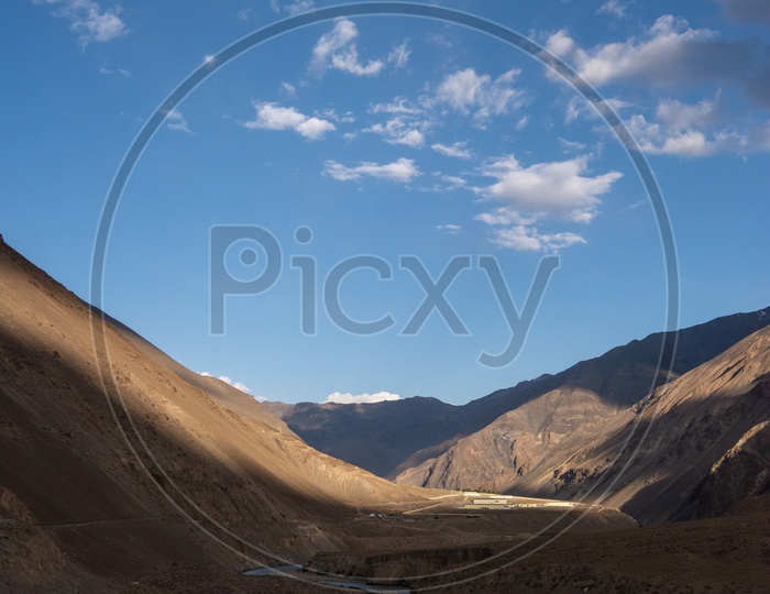 River Valleys In Leh with Sand Dunes And Blue Sky With Cotton Clouds