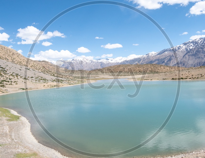 Dhankar lake with mountain peaks in the background in Spiti Valley