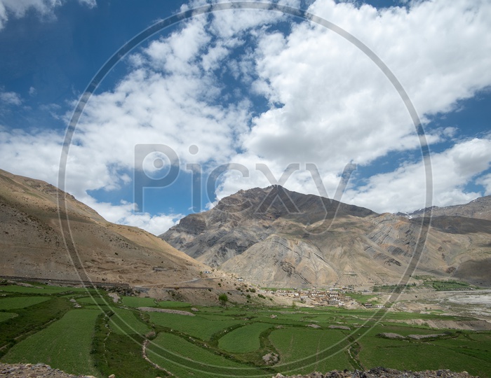 Agricultural farm lands and houses in Spiti valley with mountains in the background