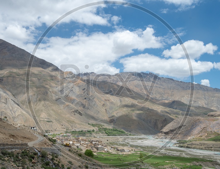 Agricultural farm lands and houses beside Spiti river with mountains in the background in Spiti Valley