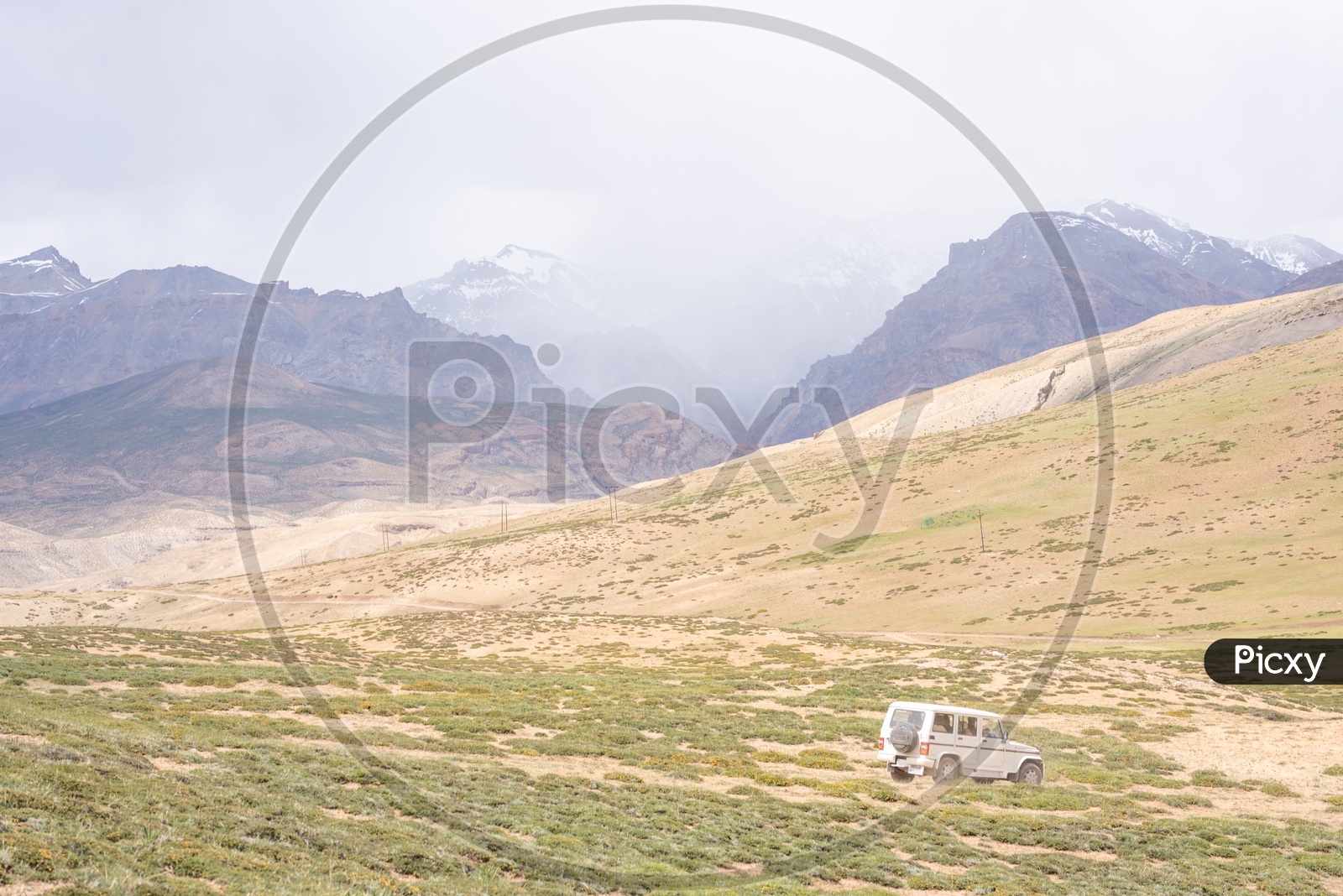 A tourist vehicle in the barren lands of Spiti Valley