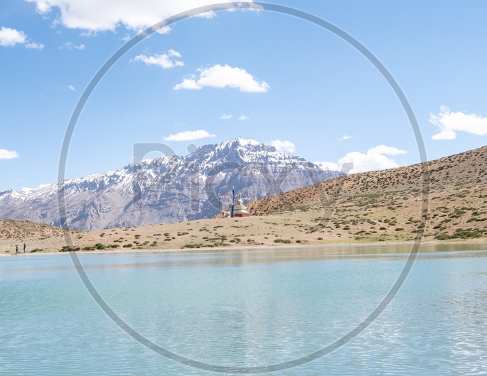 Buddhist Stupa at Dhankar lake with mountain peaks in the background in Spiti Valley