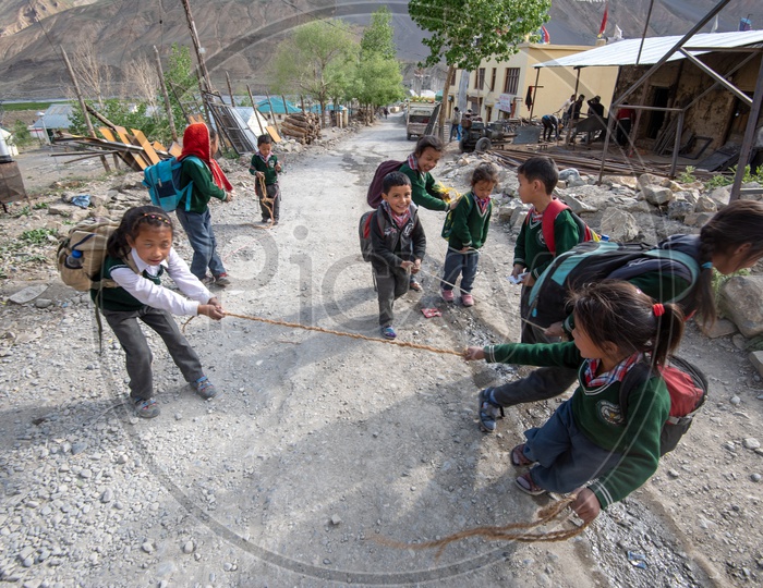 School children playing with rope on the road in Spiti Valley