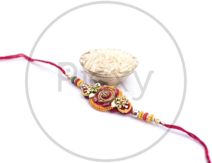 Elegant Raakhi With  Rice Grains  For Raksha Bandhan Festival