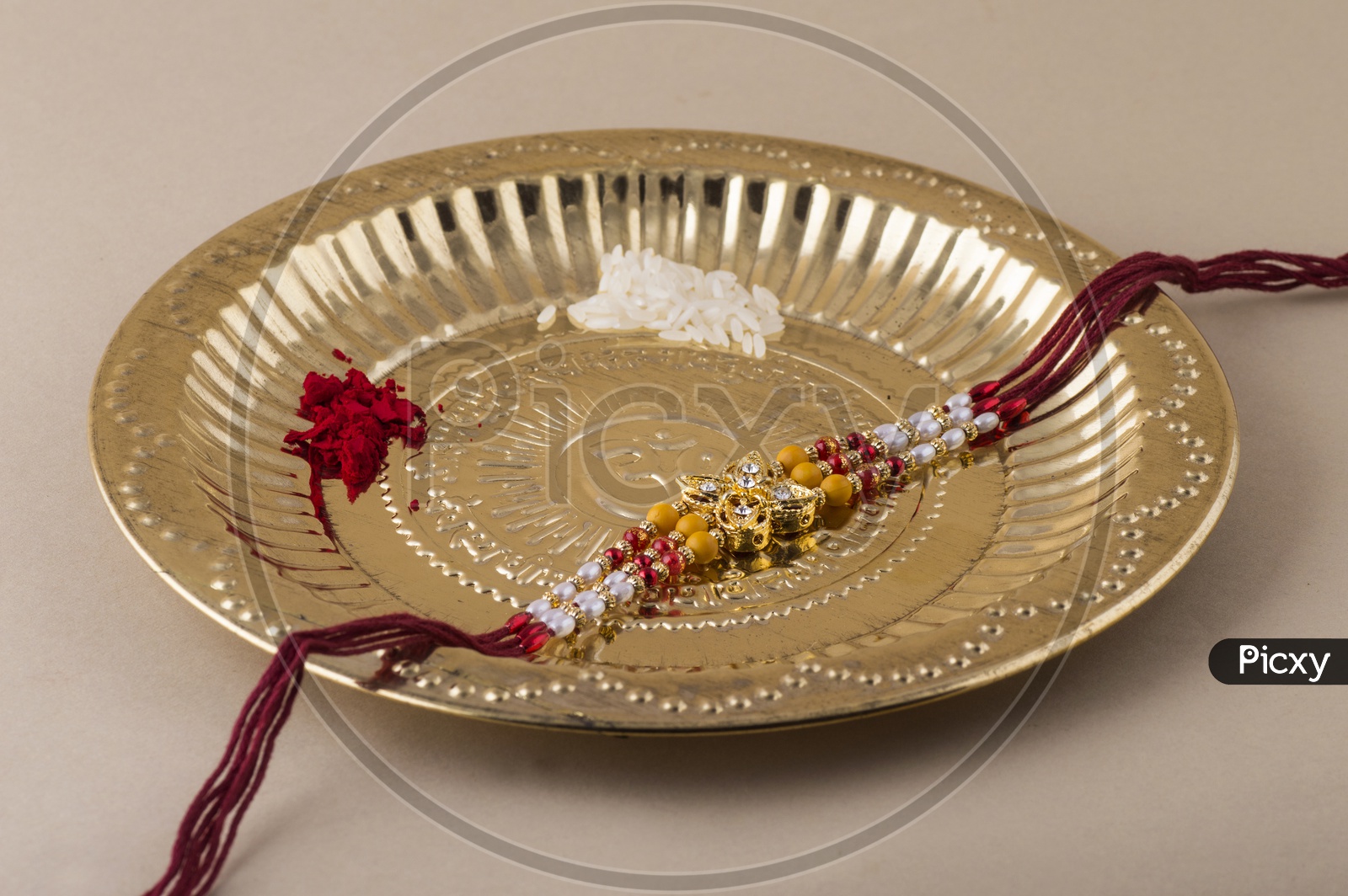 Elegant Raakhi With Rice Gains And Kumkum in Pooja Plate For Raksha Bandhan