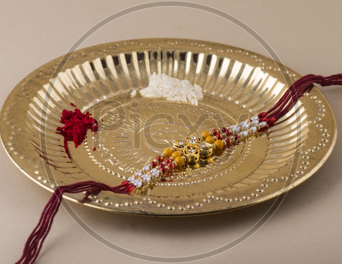 Elegant Raakhi With Rice Gains And Kumkum in Pooja Plate For Raksha Bandhan