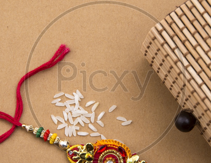 Elegant Rakhi With Rice Grains And Gift Box For Sister