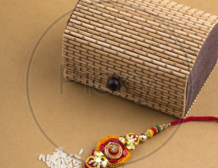 Elegant Rakhi With Rice Grains ,   Kumkum  and Gift Box For Sister