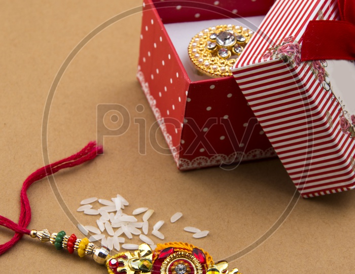 Elegant Rakhi With Rice Grains   And Gift Box For Sister