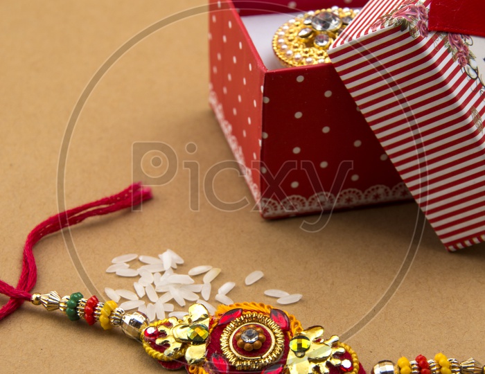 Elegant Rakhi With Rice Grains   And Gift Box For Sister