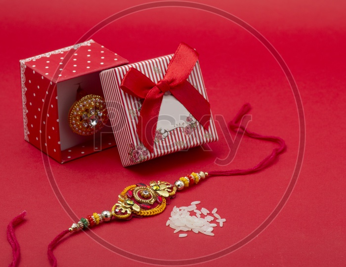 elegant Raakhi With ice Grains and Gift Box For sister On The Occasion Of Raksha Bandhan Festival