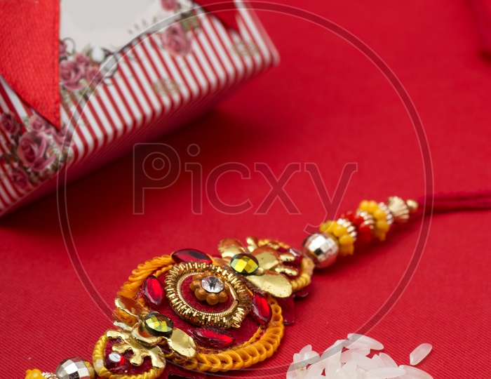 elegant Raakhi With ice Grains and Gift Box For sister On The Occasion Of Raksha Bandhan Festival