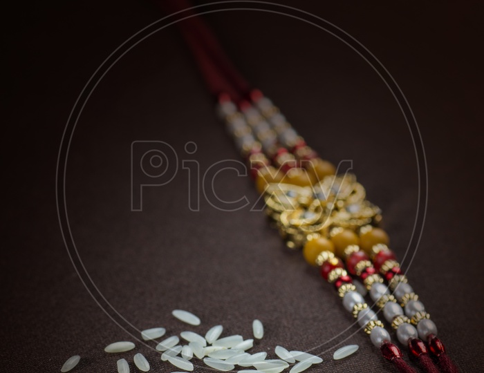 Template of Elegant  Raakhi With Rice Grains   For Raksha Bandhan Festival  Wishes