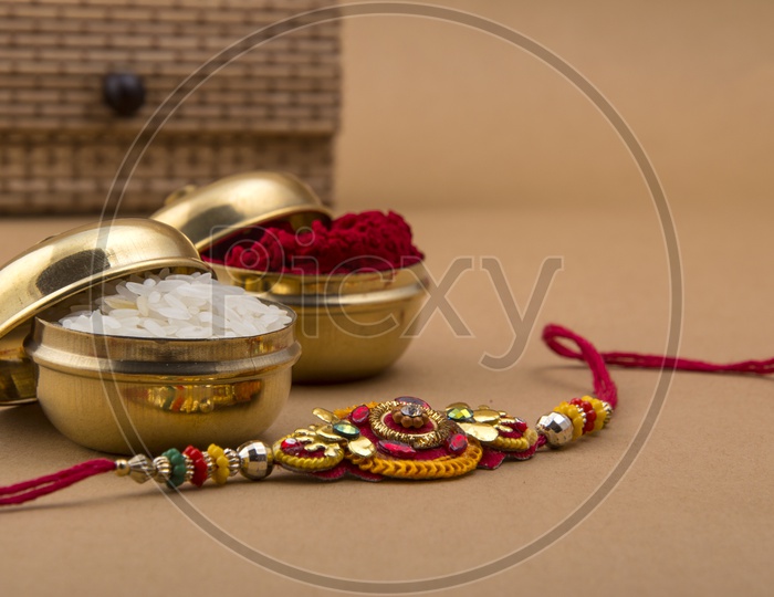 Elegant Rakhi With Rice Grains And Kumkum And Gift Box For Sister