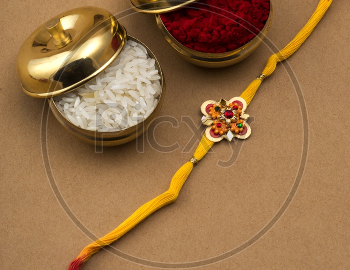Elegant Rakhi With Rice Grains And Kumkum