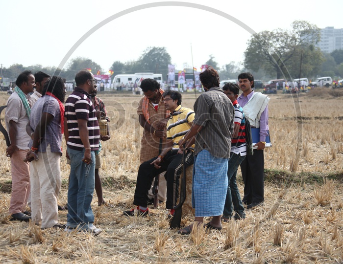 A Leader Discussing With  Their Followers in Dried Paddy Fields