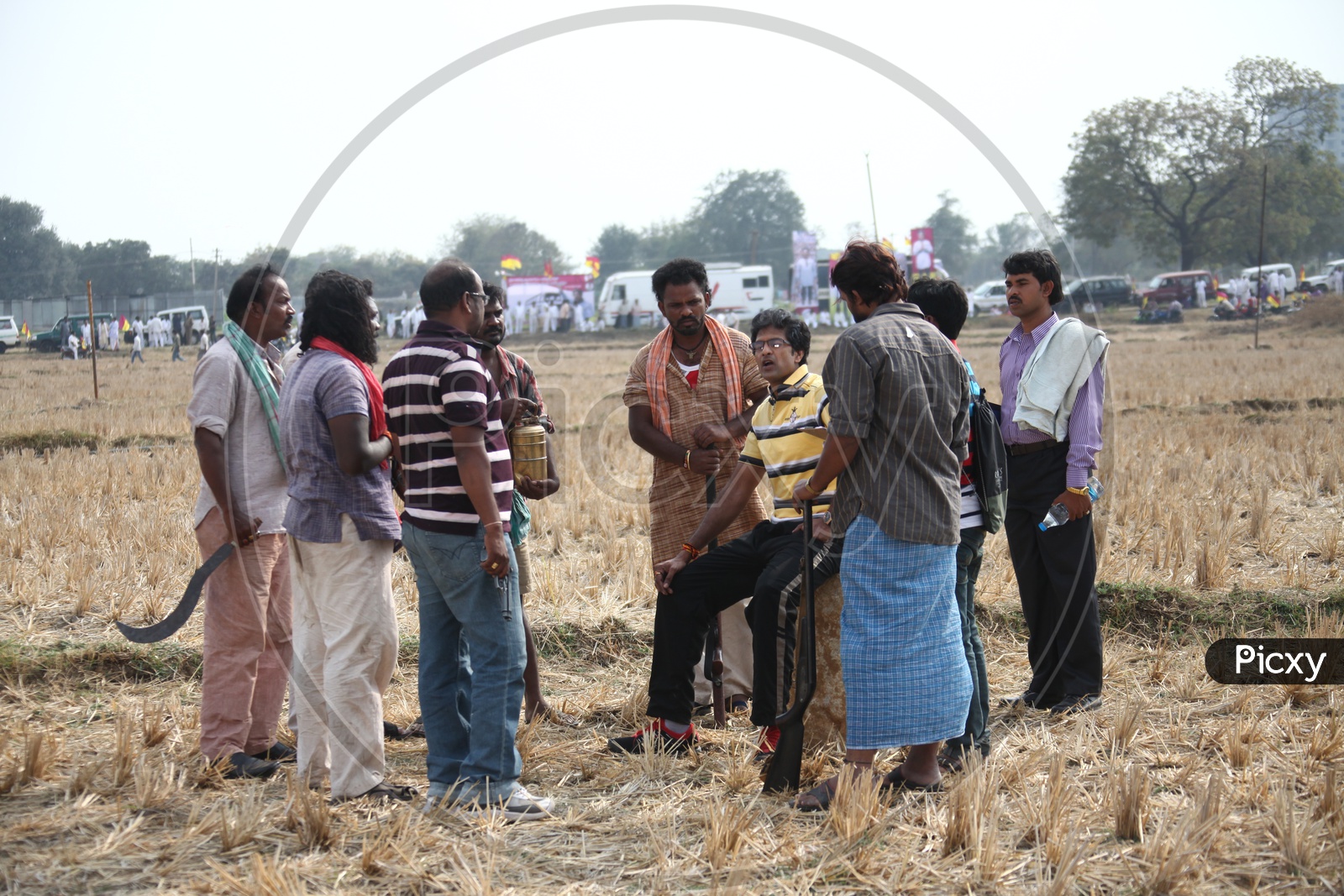 A Leader Discussing With  Their Followers in Dried Paddy Fields
