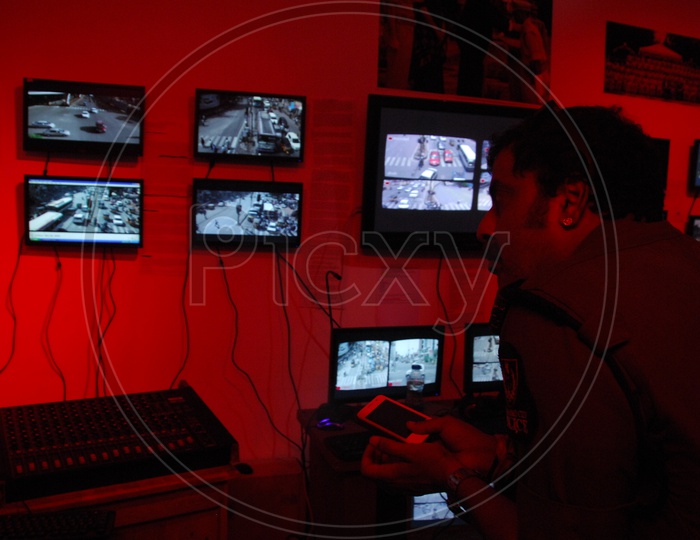 A Man Or Technician Monitoring The CCTV Live Footage In a Control Room