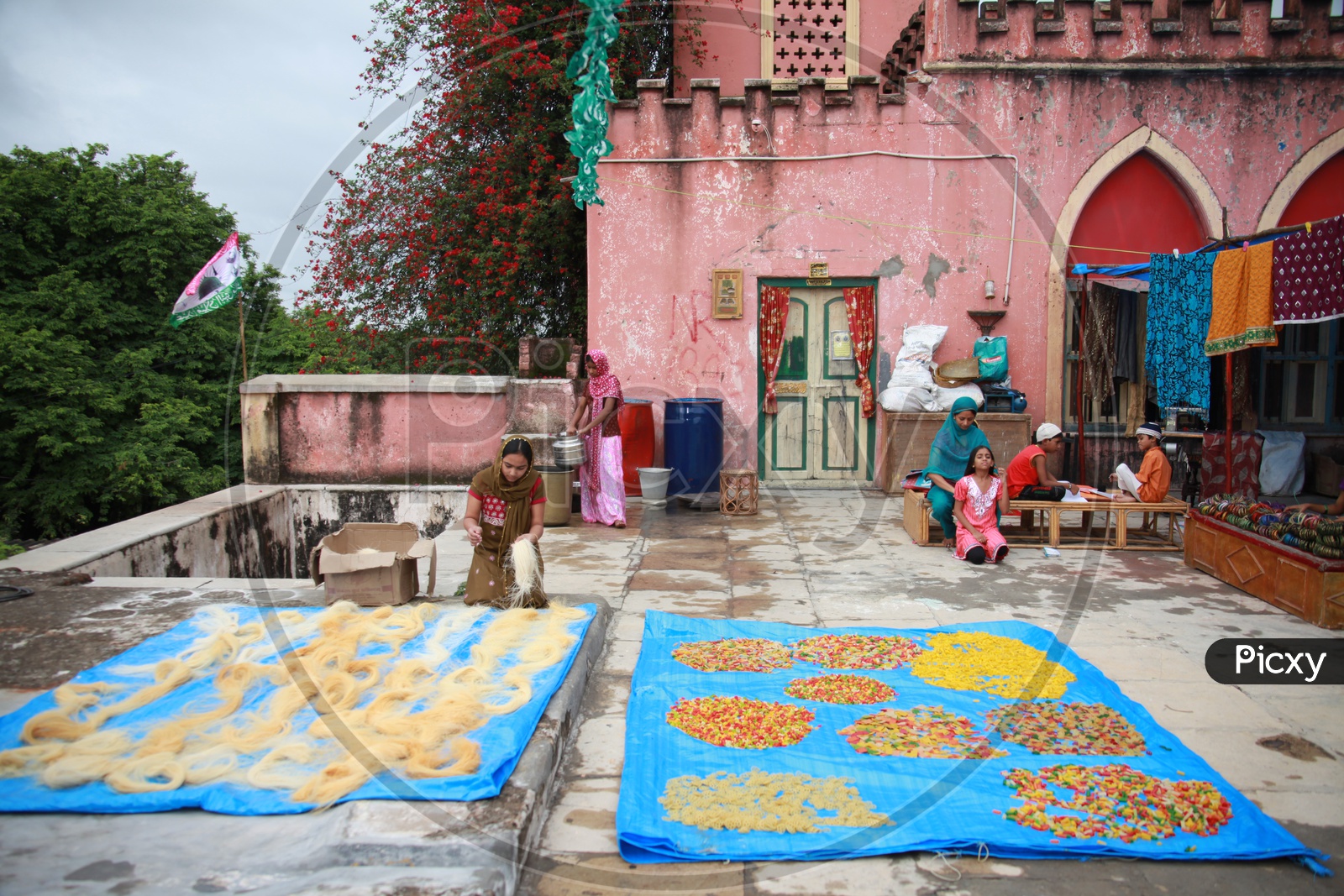 Muslim Woman Drying Semiya Or Vermicelli  On House Terrace