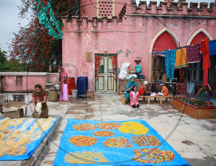 Muslim Woman Drying Semiya Or Vermicelli  On House Terrace