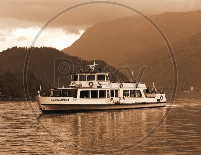 Ferry in a river with mountains in the background