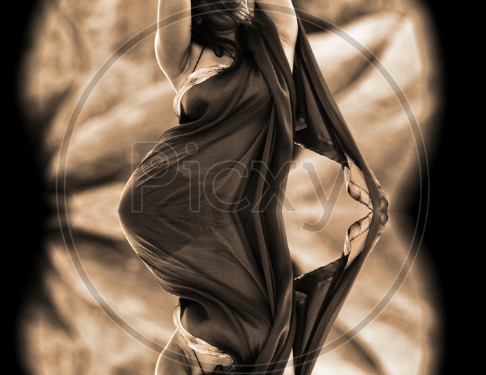Optical illusion of dance pose of a woman in saree