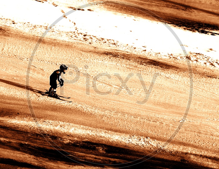 Silhouette of a boy skiing in snow