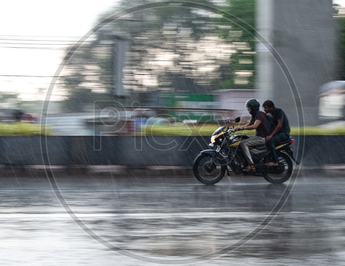 Motorcyclists Or Bike Commuters On Flooded City Roads On A Rainy Day