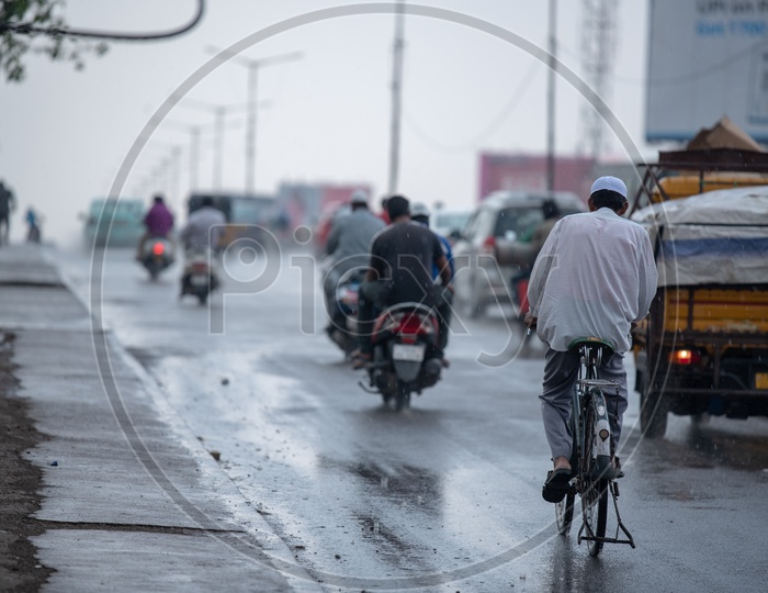 A Cyclist Riding a Bicycle on a Rainy Day