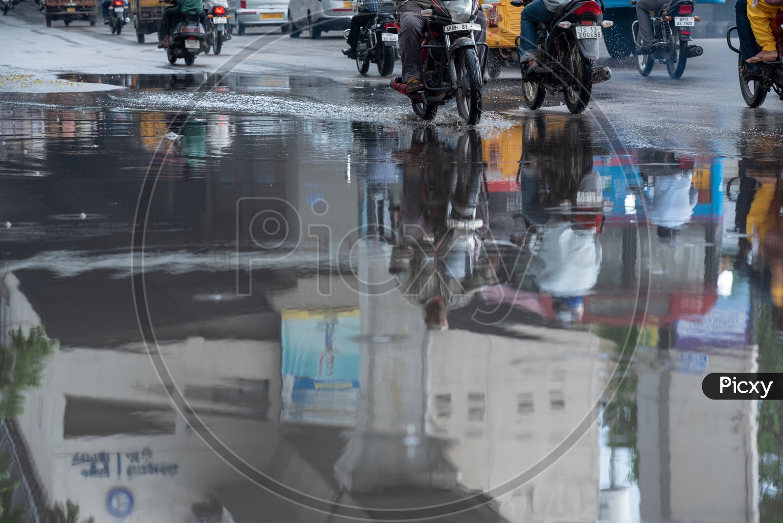 Reflection of a Motorcyclist Or Bikers  on Flooded City Roads With Water Splash on a Rainy Day