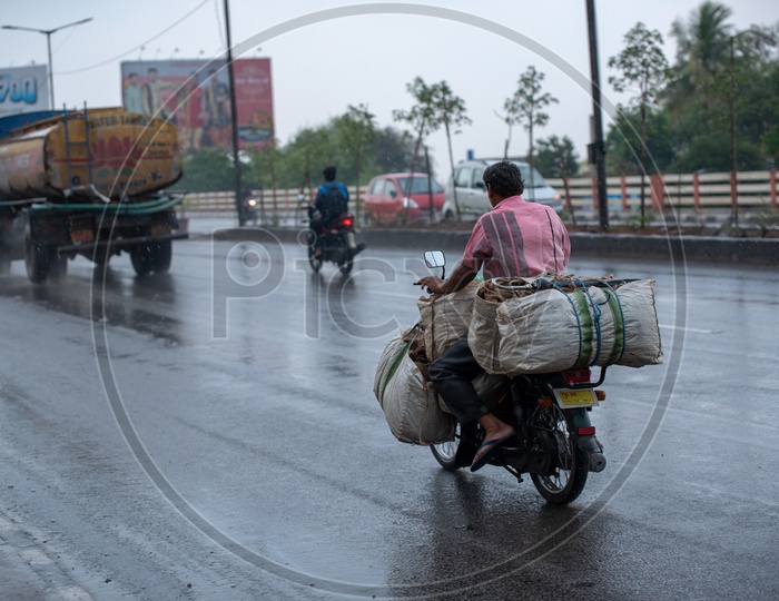 A Man Carrying Goods In Bike On a Rainy Day