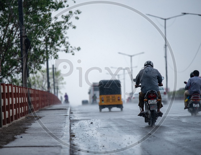 A Motorcyclist or Bike Rider On the Road In a Rainy Day