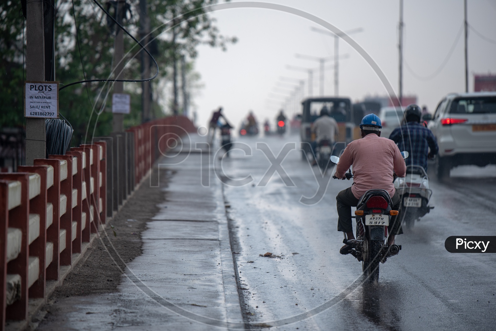 A Motorcyclist or Bike Rider On the Road In a Rainy Day