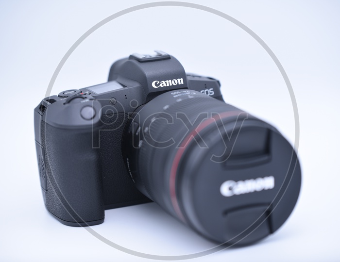 Cannon EOS R  Camera Mounted To 24 - 105 mm Lens On an Isolated White Background