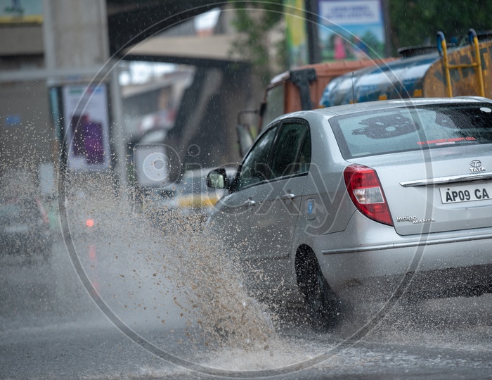 Commuting Vehicles on Flooded City Roads With Water Splash on a Rainy Day
