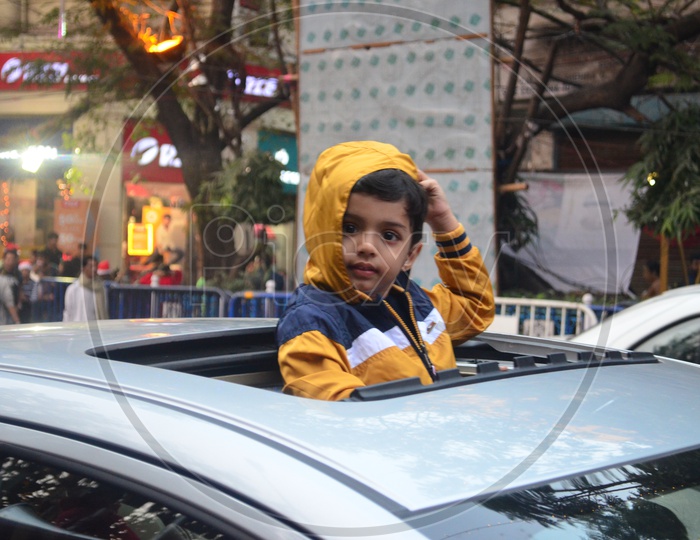 An Indian Boy  Looking Out From  Car Rear Window