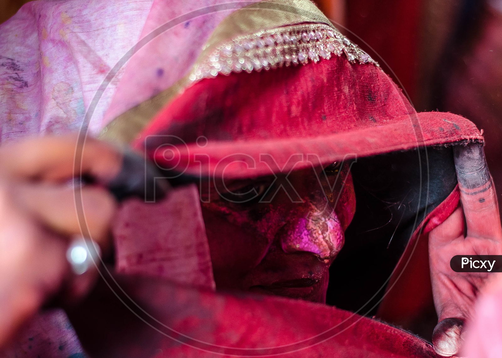 Color Filled Faces Of Indian Woman Behind Veil in Lathmar Holi Festival