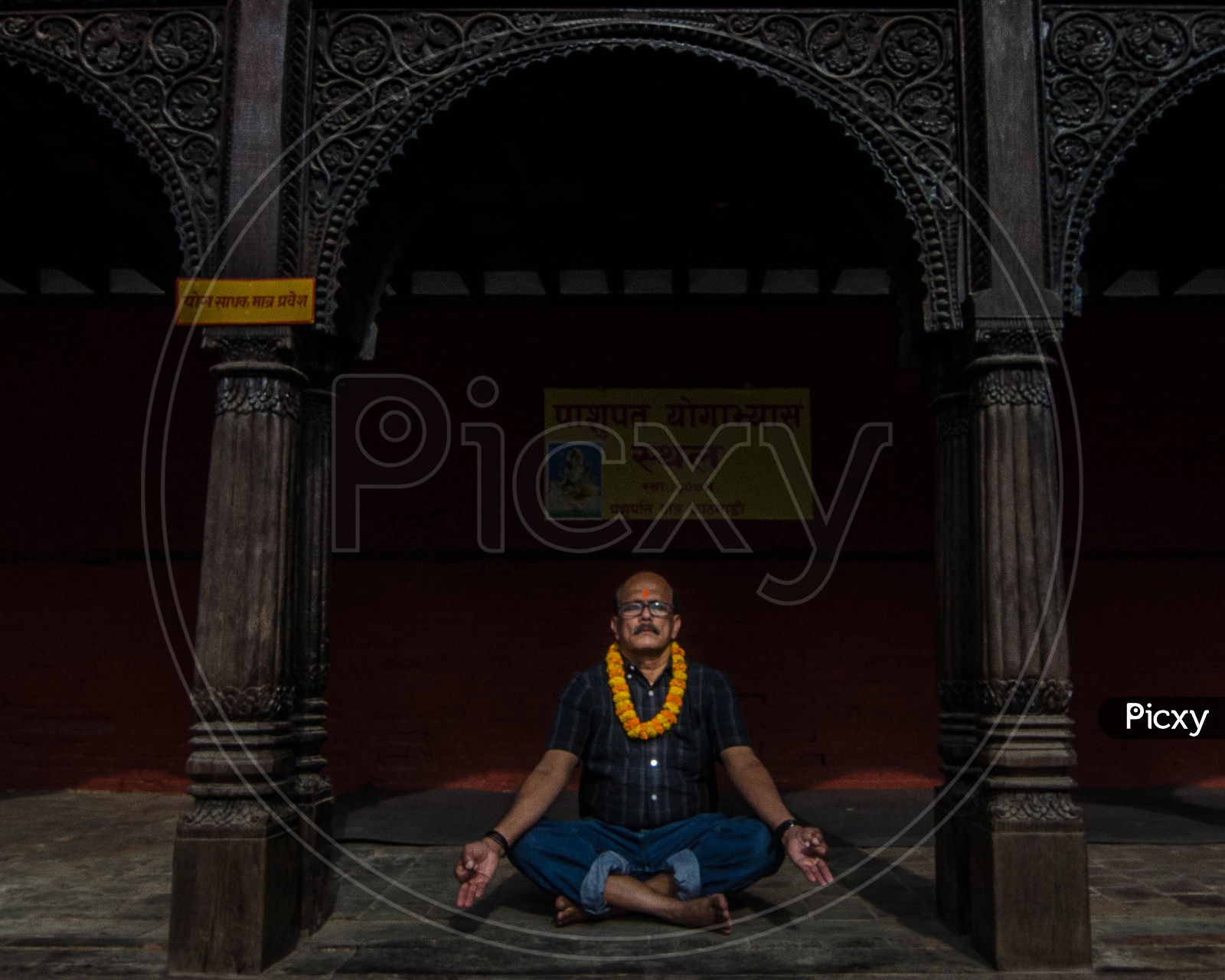 A man meditating at a temple