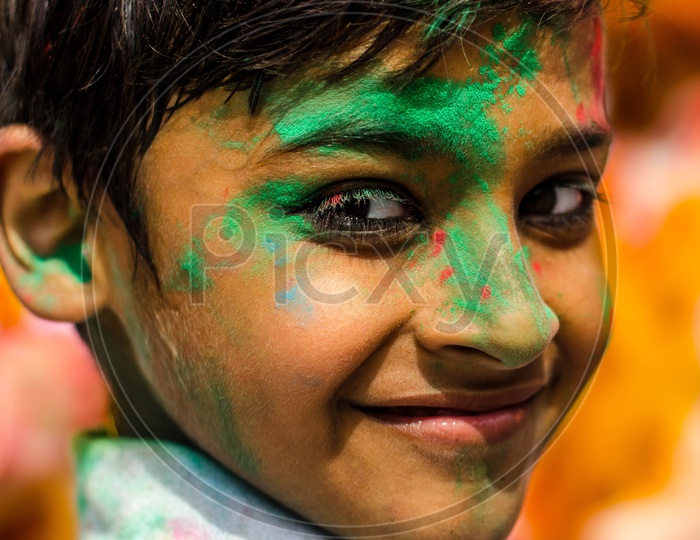Portrait of a kid with colored face