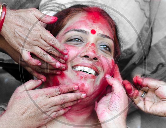 A Happy Indian Woman Face Being Painting with  Color  by Hands