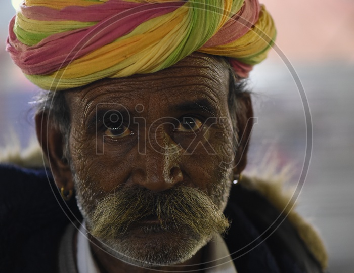 Portrait of an Indian old man with colorful turban