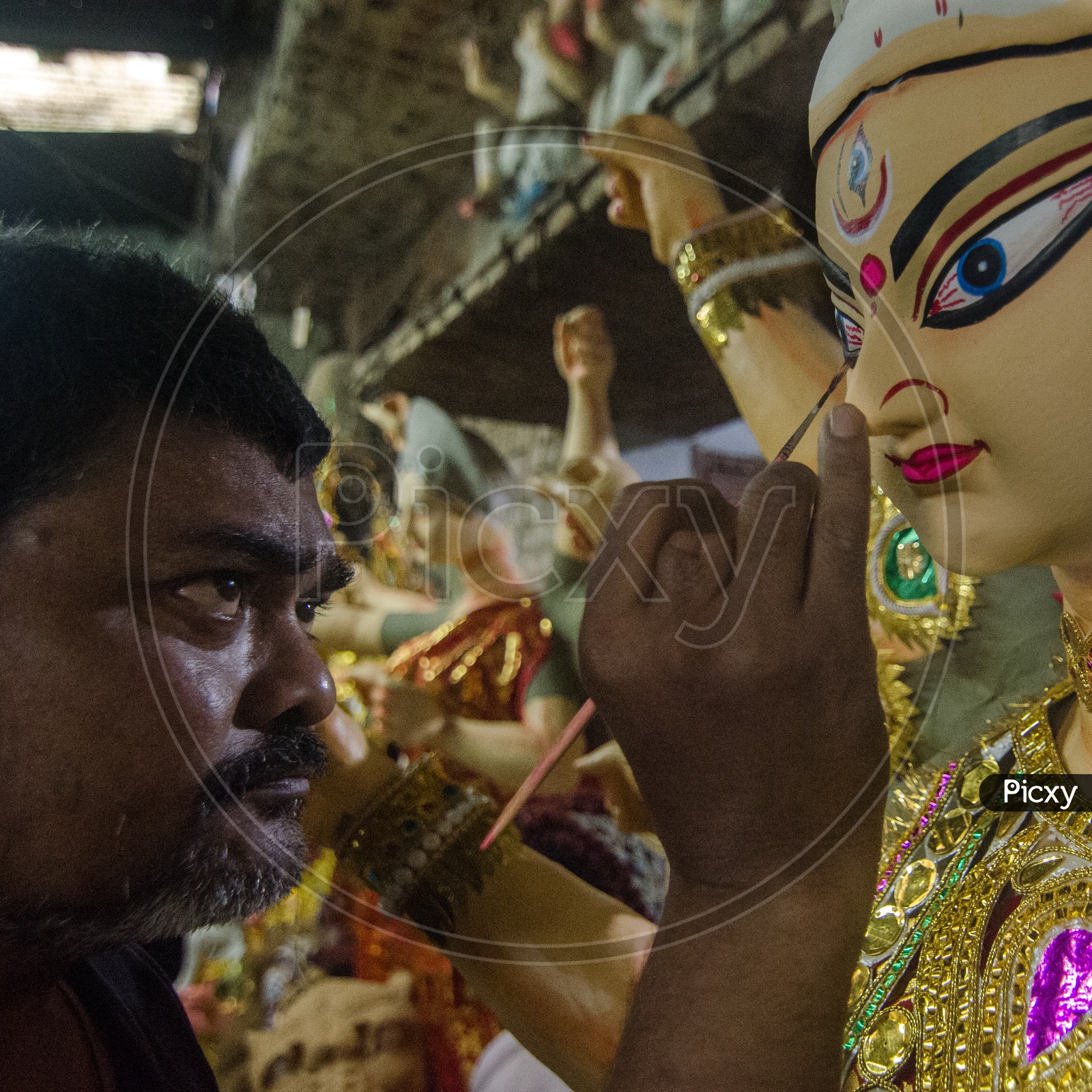 An Artist Making The Final Finishings For Hindu Goddess Statues